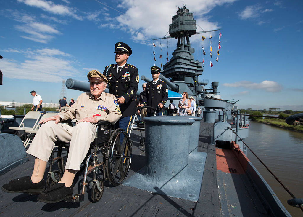 Achilles Kozakis is escorted aboard the Battleship Texas